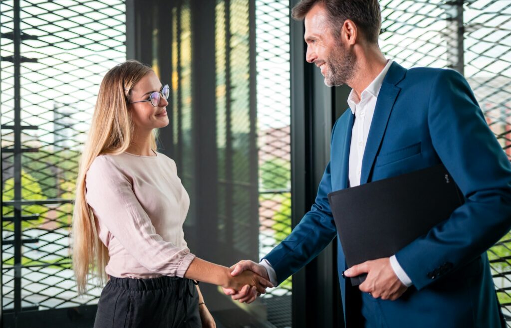 Business people shaking hands in the modern office finishing successful meeting